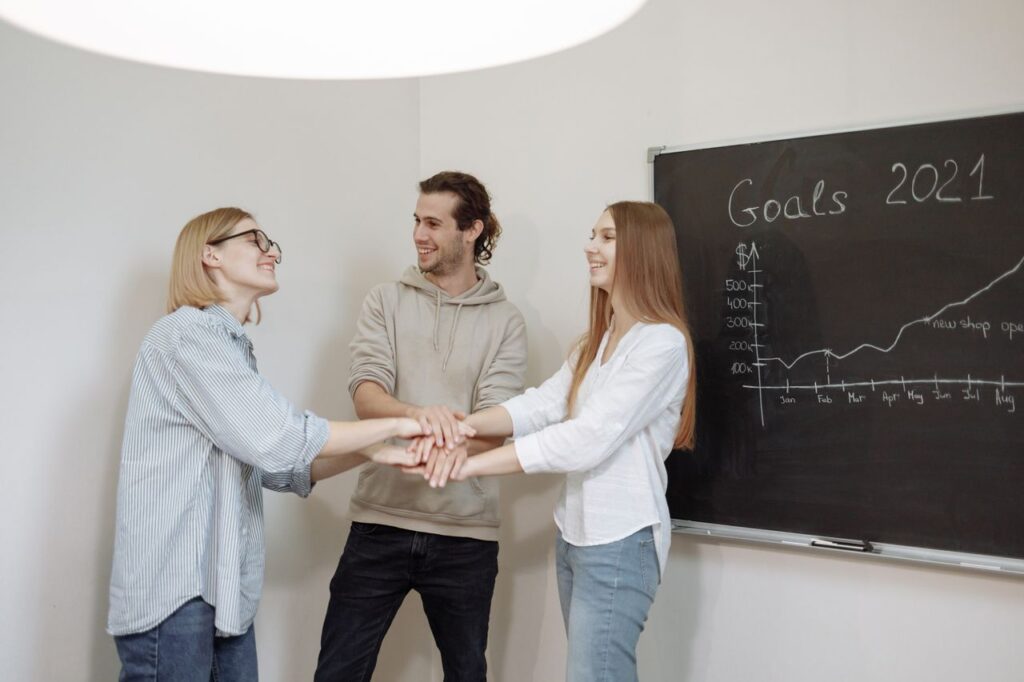 Mastering the First Impression: Your intriguing post title goes here Team celebrating business goals for 2021 with enthusiasm and teamwork in a cozy office setting.