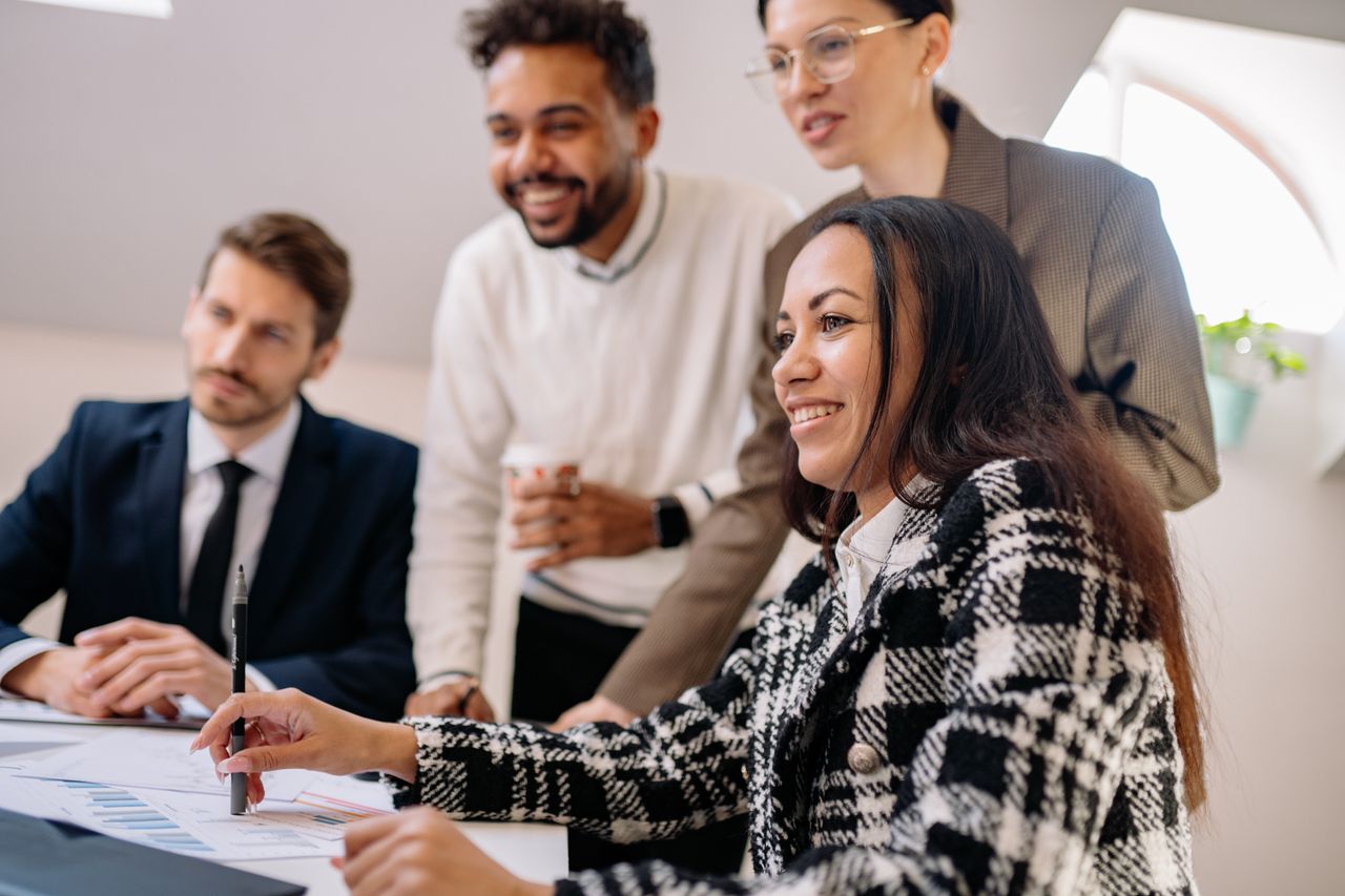 A group of professionals engaged in a collaborative business meeting, reflecting teamwork and diversity.